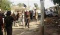  مسلحون من تنظيم الدولة ينتشرون في إحدى المناطق بمدينة تكريت التي تعرضت لقصف جوي بطائرة بدون طيار (أسوشيتد برس) 